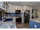 Stylish kitchen featuring stainless steel appliances, granite countertops, dark backsplash, and custom cabinetry at 15204 Westminister Ave, Clearwater, FL 33760