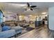 Open-concept living room flowing into dining and kitchen area, with modern flooring and neutral color scheme at 15204 Westminister Ave, Clearwater, FL 33760