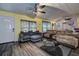 Spacious living room featuring stylish ceiling, ceiling fan, and comfortable seating with great natural light at 15204 Westminister Ave, Clearwater, FL 33760