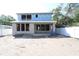 Image displays the backside of a new home under construction with an unfinished backyard and blue sky above at 1627 48Th N Ave, St Petersburg, FL 33714