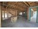 Unfinished living room with exposed wood beams, bare concrete floors, and abundant natural light at 1627 48Th N Ave, St Petersburg, FL 33714