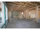 Unfinished living room with exposed wood beams, bare concrete floors, and abundant natural light at 1627 48Th N Ave, St Petersburg, FL 33714