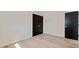 A bedroom featuring light floors and two closet doors with gold hardware at 1981 Briarwood St, Dunedin, FL 34698