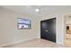 Bright bedroom featuring a ceiling fan, closet, and a large window at 1981 Briarwood St, Dunedin, FL 34698