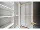 Walk-in closet with custom shelving units, providing ample storage space at 1981 Briarwood St, Dunedin, FL 34698
