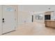 Inviting entryway leads to an open living space and eat-in kitchen with light wood floors at 1981 Briarwood St, Dunedin, FL 34698
