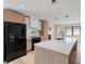 Spacious kitchen features custom cabinets, black appliances, and a large center island at 1981 Briarwood St, Dunedin, FL 34698
