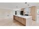 Beautiful kitchen with large center island, modern appliances, and hardwood flooring at 1981 Briarwood St, Dunedin, FL 34698