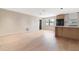 Bright open living space featuring wood flooring and modern accents with access to a modern kitchen at 1981 Briarwood St, Dunedin, FL 34698