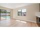 Bright living area with sliding glass doors to the pool and hardwood flooring at 1981 Briarwood St, Dunedin, FL 34698