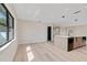 Bright and airy living space leading into a modern kitchen with hardwood flooring at 1981 Briarwood St, Dunedin, FL 34698
