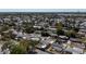 Picturesque neighborhood aerial view featuring tree-lined streets and a tranquil lake in the distance at 2122 Holiday Dr, Holiday, FL 34691