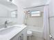 Bathroom with modern vanity, white tiled walls, and shower-tub combination at 2122 Holiday Dr, Holiday, FL 34691