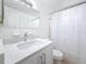 Clean bathroom with a new vanity and well-lit mirror with shower and tub at 2122 Holiday Dr, Holiday, FL 34691