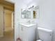 Bright bathroom featuring a vanity, sink, mirror and toilet at 2122 Holiday Dr, Holiday, FL 34691