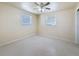 Cozy bedroom featuring neutral tones, two windows, and comfortable space at 2122 Holiday Dr, Holiday, FL 34691