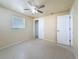 Bright bedroom features a ceiling fan and a window letting in natural light at 2122 Holiday Dr, Holiday, FL 34691