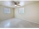 Comfortable bedroom with a ceiling fan and natural light from two windows at 2122 Holiday Dr, Holiday, FL 34691