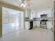 Modern kitchen featuring white cabinets, stainless steel appliances, and granite countertops at 2122 Holiday Dr, Holiday, FL 34691