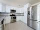 Well-equipped kitchen with stainless steel appliances, white cabinetry, and attractive granite countertops at 2122 Holiday Dr, Holiday, FL 34691