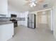 Stylish kitchen showcasing stainless steel appliances, granite countertops, and bright white cabinets at 2122 Holiday Dr, Holiday, FL 34691