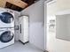 Functional laundry room with stacked washer/dryer units and storage cabinets; convenient access to the kitchen at 2122 Holiday Dr, Holiday, FL 34691