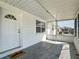 Inviting covered porch with a Welcome mat leading to a paneled front door at 2122 Holiday Dr, Holiday, FL 34691