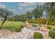 Beautiful backyard featuring a fire pit and two wooden chairs, perfect for outdoor relaxation and entertaining at 2218 132Nd E Pl, Parrish, FL 34219