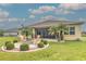 Inviting backyard with fire pit, lush landscaping, and a view of the home at 2218 132Nd E Pl, Parrish, FL 34219