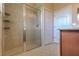 Walk-in shower with tile and glass doors, a shower head, shelves, and multiple doors leading to other spaces at 2218 132Nd E Pl, Parrish, FL 34219