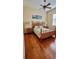 Bright bedroom features hardwood floors, ceiling fan, and a tropical themed decor at 2218 132Nd E Pl, Parrish, FL 34219
