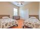 Guest bedroom featuring two twin beds, dresser, seashell bedding, and a window allowing for lots of natural light at 2218 132Nd E Pl, Parrish, FL 34219