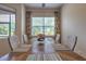 Bright dining room with wicker chairs, a wooden table, and floral curtains creating an inviting space at 2218 132Nd E Pl, Parrish, FL 34219
