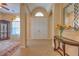 The front entrance features an elegant table and mirror adjacent to an open living space with arched doorways at 2218 132Nd E Pl, Parrish, FL 34219