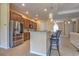 Contemporary kitchen featuring stainless steel appliances, bar seating, and a view into the living room at 2218 132Nd E Pl, Parrish, FL 34219