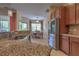 Bright kitchen with stainless steel refrigerator, seamlessly connected to the dining area for easy entertaining at 2218 132Nd E Pl, Parrish, FL 34219