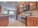 Modern kitchen featuring stainless steel appliances and seamless access to the dining area at 2218 132Nd E Pl, Parrish, FL 34219