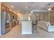 Modern kitchen featuring stainless steel appliances, granite countertops, an island, and an open floor plan at 2218 132Nd E Pl, Parrish, FL 34219
