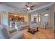 Bright, open living room features tile floors, ceiling fan, and flows into the kitchen and dining area at 2218 132Nd E Pl, Parrish, FL 34219