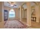 Open living space with columns, neutral paint, a large rug, and an elegant display cabinet at 2218 132Nd E Pl, Parrish, FL 34219