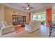 This living room is spacious and naturally lit with modern furnishings and access to the patio at 2218 132Nd E Pl, Parrish, FL 34219