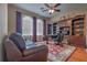 Spacious office featuring wood floors, a large bookcase, and a leather couch at 2218 132Nd E Pl, Parrish, FL 34219