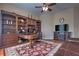 Spacious office with hardwood floors, built-in shelving, and a cozy fireplace at 2218 132Nd E Pl, Parrish, FL 34219
