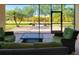 Private screened-in patio with views of the landscaped yard and charming fire pit area at 2218 132Nd E Pl, Parrish, FL 34219
