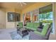Cozy screened-in patio with stylish wicker furniture and a view of the surrounding nature at 2218 132Nd E Pl, Parrish, FL 34219