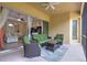 Screened patio with comfortable outdoor furniture, a ceiling fan, sliding glass doors, and access to the backyard at 2218 132Nd E Pl, Parrish, FL 34219