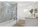 Bathroom boasts a modern shower with glass doors, updated vanity with a quartz counter, and stylish fixtures at 2328 Dartmouth N Ave, St Petersburg, FL 33713