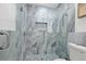 Modern bathroom featuring a frameless glass shower with stylish blue and grey tiling, and a built-in niche at 2328 Dartmouth N Ave, St Petersburg, FL 33713