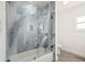 Bathroom with a tiled shower and glass door, complemented by modern fixtures and finishes at 2328 Dartmouth N Ave, St Petersburg, FL 33713