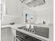 A brightly lit modern kitchen features stainless steel appliances, white cabinets, a large island, and updated flooring at 2328 Dartmouth N Ave, St Petersburg, FL 33713